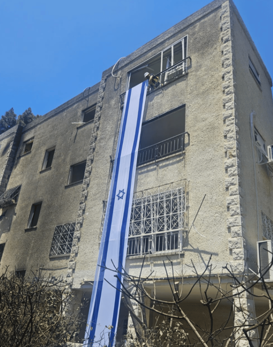 Israeli Flags Raised Over Missile-Damaged Buildings in Haifa