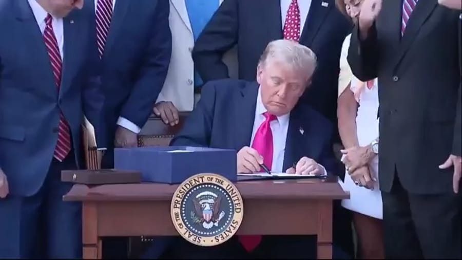 Signing the bill.