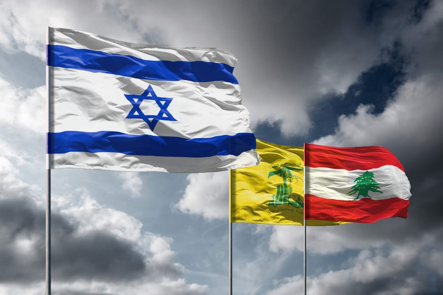 Israel, Lebanon, and Hezbollah flags.