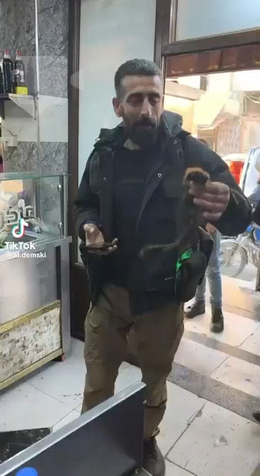 Syrian fighter proudly shows off ponytail he cut off of a kurdish woman