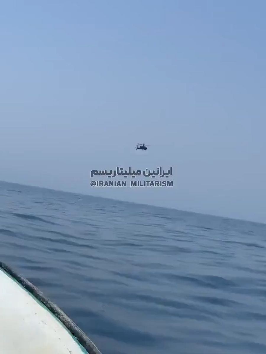 The fisherman lay down on the deck and documented the Apache helicopter subduing a tanker.