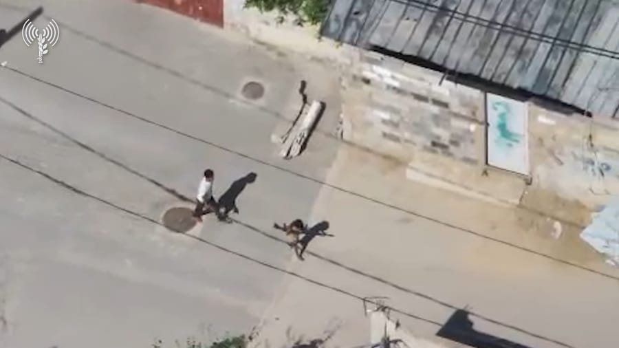 Footage of the child moving combat equipment into the civilian building