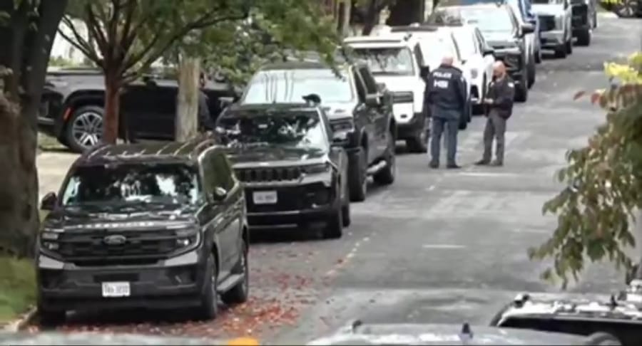 Agents at the entrance to Ilhan Omar's home