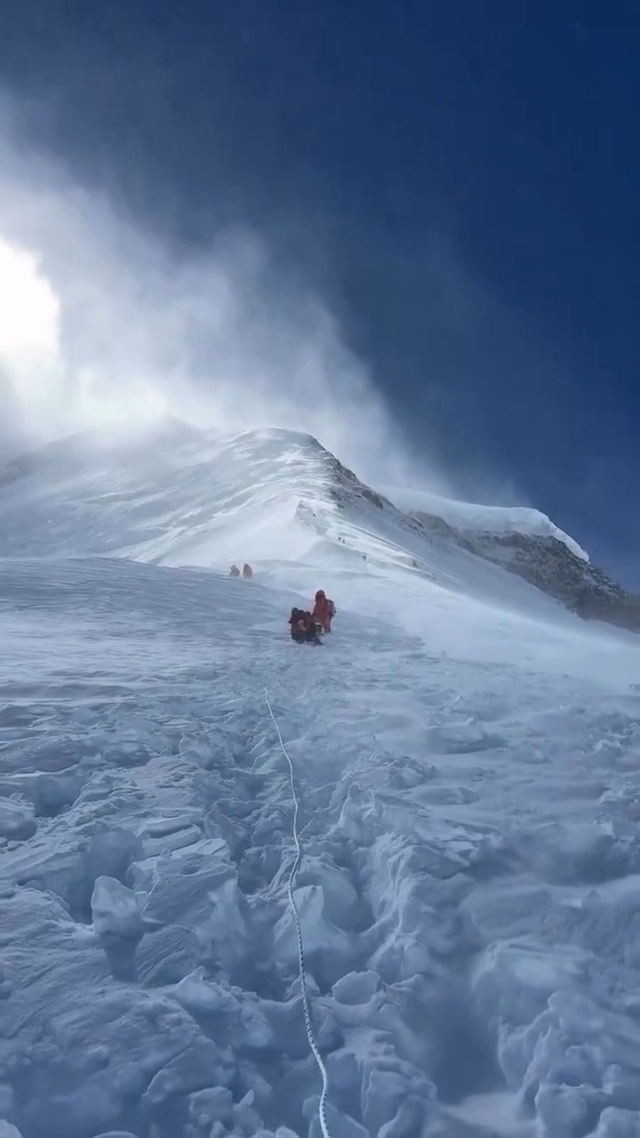 Footage from a climber's perspective shows fierce winds and heavy snow near Camp 3