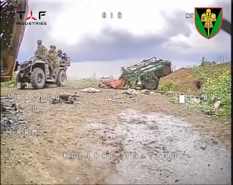 A cat flees moments before Russian soldiers appear on the drone feed
