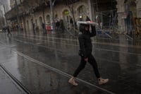 People carry umbrellas (or other objects..) as they protect themselves from the rain, in jerusalem. January 23, 2024.