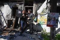 Herzog and Milei talk amongst the ruins of Nir Oz.