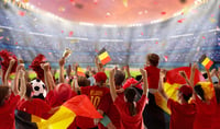 Belgian supporters watch soccer on outdoor field.