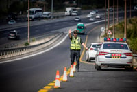 A traffic police officer from the Israeli national traffic police stopping a driver on road number 1 near Ein Hemed.