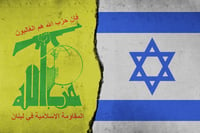 Hezbollah and Israeli flags on a divided wall: Symbolizing the Israel-Hezbollah Conflict