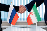 Illustrative: Political flags of Russia and Iran on table in international negotiation room