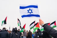 A counter-protestor holds the flag of Israel at an anti-Israel protest in a Jewish neighbourhood of Armour Heights in Toronto 