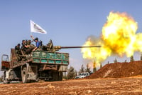 Military vehicles of the Syrian opposition fire on ISIS positions