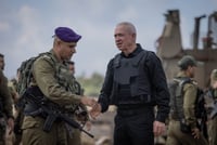 Defence Minister Yoav Gallant speaks with Israeli soldiers at a staging area not far from the Israeli-Gaza border