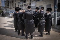 Hasidim carrying their rifles outside a wedding of the Gur Hasidic dynasty