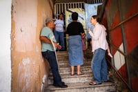 People take cover as a siren warns of incoming missiles fired from Lebanon, in the northern Israel city of Tzfat, September 26, 2024. 