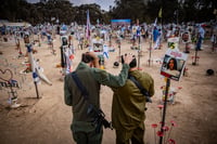 Israelis visit the site of the Re'im music festival massacre, in southern Israel, October 6, 2024.