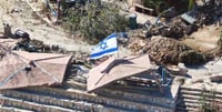 Israeli flag flies over key Lebanese village