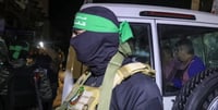 Hamas fighter next to a Red Cross vehicle 