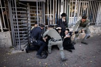 Ultra orthodox Jews scuffle with police during a protest against the drafting of ultra orthodox jews outside an IDF Recruitment Center in Jeursalem