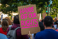  Protestor holds Sign "Hands off our Rights" displayed during Protest in Front of US Supreme Court Building 