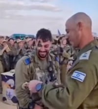 Lt. Col. Tal Iglitzki gives his son his beret