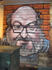 Portrait of Jonathan Pollard spray-painted on corrugated shutter of a stall at the Mahane Yehuda Market, Jerusalem, Israel.