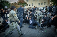 Ultra Orthodox men protest mandatory recruitment into the IDF