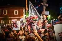 Person holds up poster of Hamas hostage