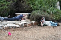 People take cover as a siren sounds a warning of incoming missiles fired from Lebanon during the funeral of Israeli soldier First sergeant Yair Hananya in Mitzpe Netofa