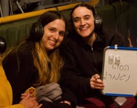 2 of the 3 released hostages holding a sign "the nightmare is over"