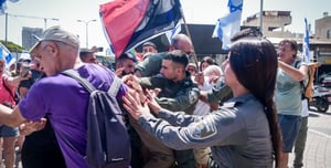 The protesters confront the police officers outside the station