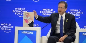 President Herzog Presents Image of Kfir Bibas at the Annual World Economic Forum Meeting in Davos
