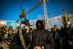 Armed Palestinian gunmen take part in a military parade, in Jenin, February 24, 2024. 