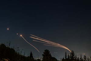 Iron dome anti-missile system fires interception missiles as rockets fired from Lebanon, as it seen over the Hula Valley, April 12, 2024. 