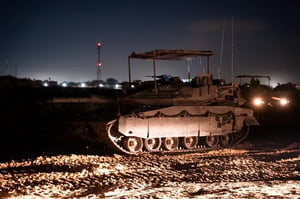 Armored vehicle operating at night in Rafah area.