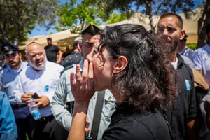 People react during a speech of Minister of National Security Itamar Ben Gvir at an official Memorial Day ceremony which commemorates the fallen Israeli soldiers and victims of terror in Ashdod Military Cemetery on May 13, 2024. 