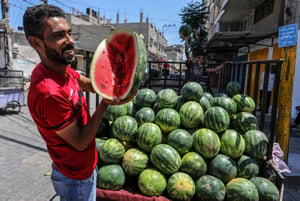 Palestinians sell watermelon at the market in Rafah, in southern Gaza Strip, on July 14, 2023. 