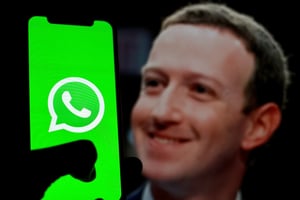 Mark Zuckerberg next to WhatsApp mobile app on an iPhone. 