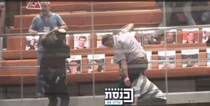 Protestors clashing in the Knesset with ushers.