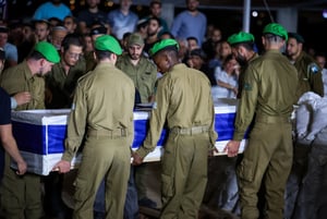 Friends and family attend the funeral of Israeli soldier Staff sergeant Tzur Avraham at the military cemetery in Modi'in June 16, 2024. 