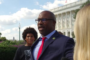 U.S. Rep. Jamaal Bowman walks with reporters outside the U.S. Capitol.