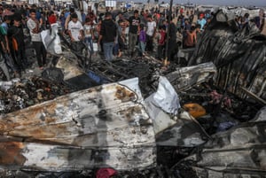 Palestinians inspect damage after an Israeli air strike,  in the Al-Mawasi area, west of the city of Rafah in the southern Gaza Strip. 