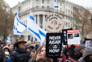 Pro-Israeli protesters at the "March Against Antisemitism" hold flags and placards in support of hostages taken by Hamas in Gaza.