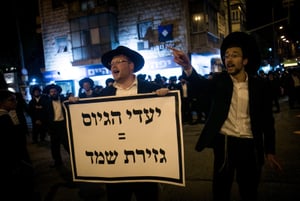 Ultra-Orthodox demonstrators protest at the Bar Ilan intersection in Jerusalem 
