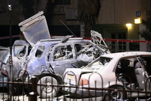 Israeli bomb squad police unit investigate a car which was bombed.