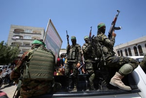 Masked militants from the Izzedine al-Qassam Brigades, a military wing of Hamas,  in Jabaliya refugee camp, northern Gaza Strip.