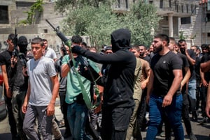 Armed Palestinians attend a funeral in Kafr Dan, west of Jenin, in the West Bank, June 12, 2024