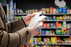 Man viewing receipts in a supermarket 