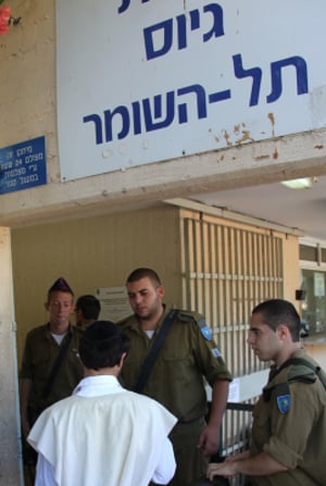 Ultra-Orthodox Jewish men arrive at the Bakum Reception and Sorting base in Tel Hashomer  